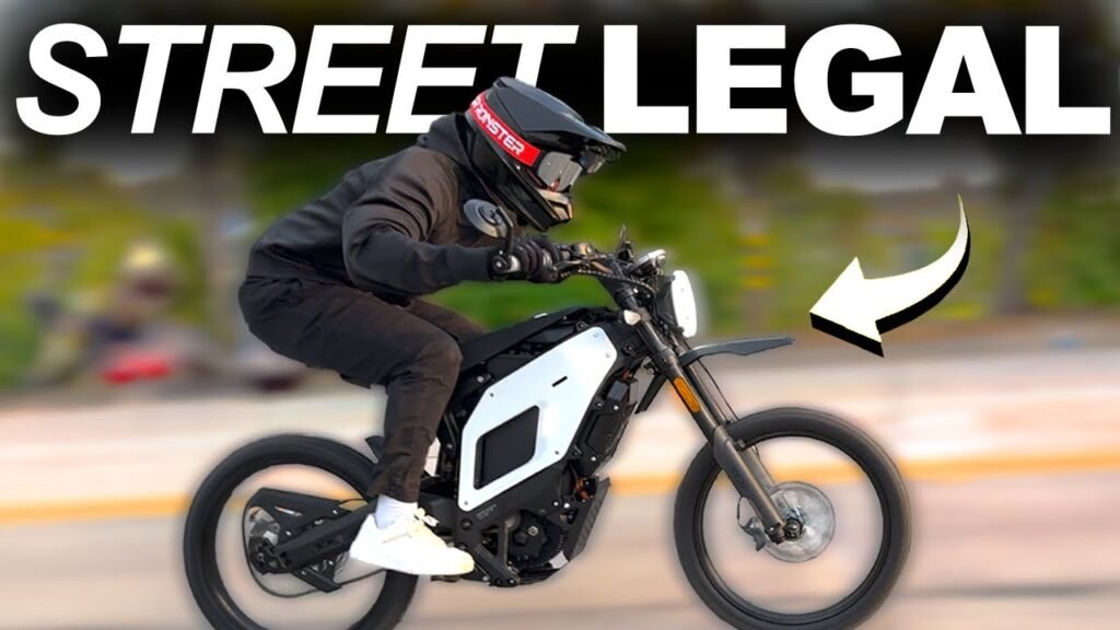 Street legal electric dirt bike equipped with mirrors, lights, and license plate for road riding
